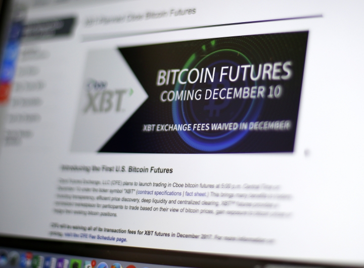 The Latest: Bitcoin futures end 1st day 20 pct higher