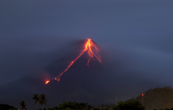 Glowing red lava causes more to flee from Philippine volcano